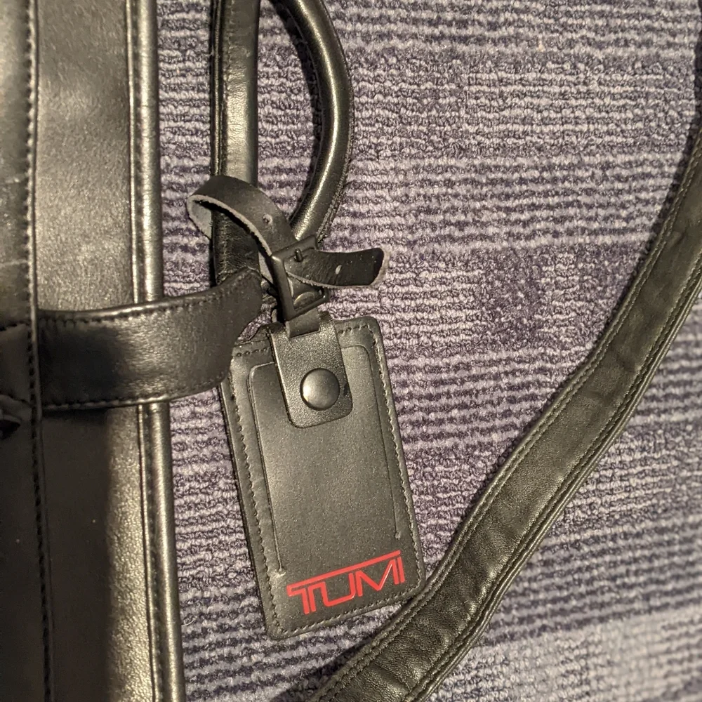 Black Tumi expandable briefcase. Fits 15